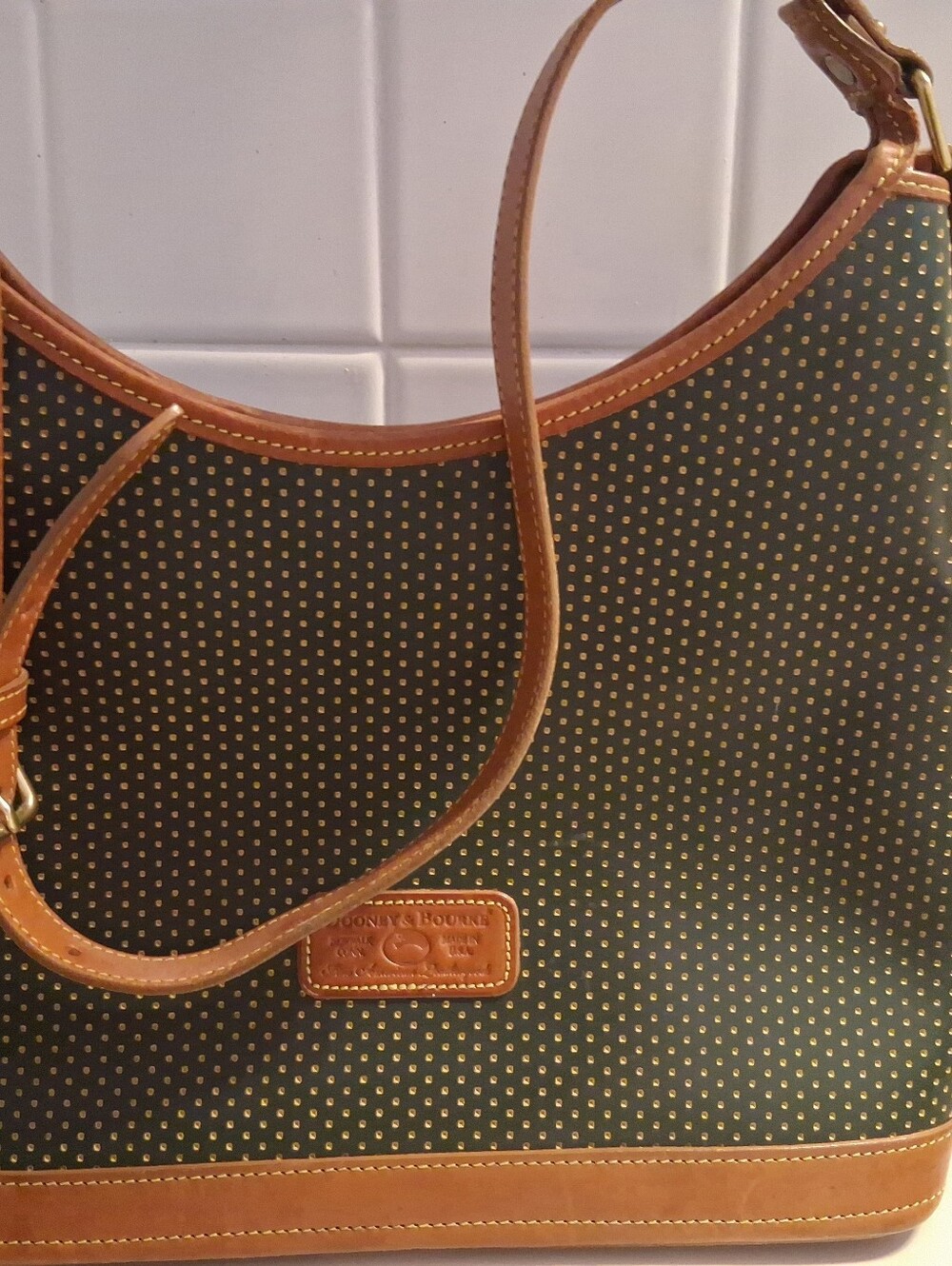 A pristine Vintage Dooney & Bourke Cabrio Black Hobo Shoulder Bag with Tan Trim